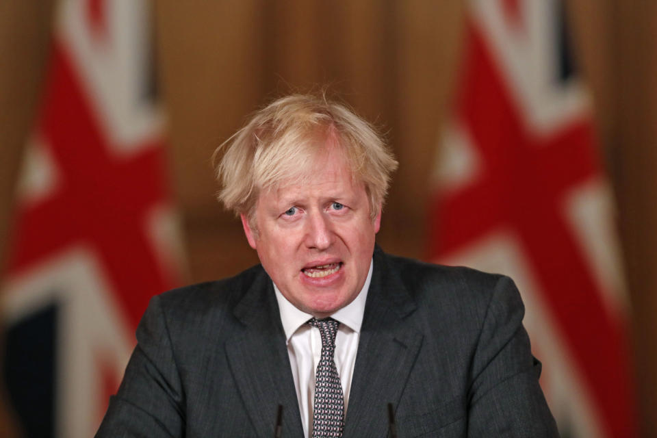 Britain's Prime Minister Boris Johnson speaks at a press conference in 10 Downing Street, London, Wednesday Dec. 30, 2020. The British government on Wednesday extended its toughest coronavirus restrictions to more than three-quarters of England’s population, saying a fast-spreading new variant of the virus has reached most of the country.