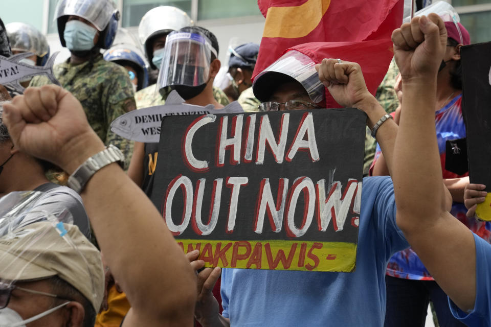 Protesters hold slogans during a rally in front of the Chinese Consulate in Makati city, Philippines on Monday, July 12, 2021. The demonstration was held to commemorate the 5th anniversary of the Arbitral Ruling in The Hague by the UNCLOS (United Nations Convention on the Law of the Sea) granting the Philippines the exclusive right to fish within its Exclusive Economic Zone or EEZ. (AP Photo/Aaron Favila)