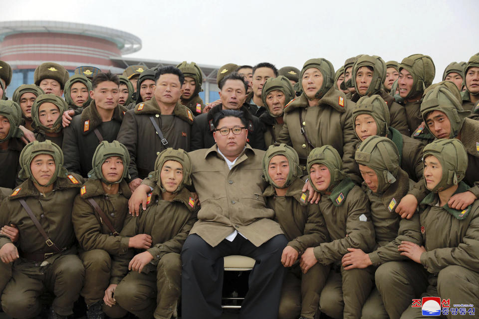 In this undated photo provided on Monday, Nov. 18, 2019, by the North Korean government, North Korean leader Kim Jong Un, center, poses with North Korean air force sharpshooters and soldiers for a photo at an unknown location in North Korea. Kim supervised a parachuting drill of military sharpshooters and vowed to build an “invincible army,” displaying more defiance even as the United States and South Korea called off their own exercises to create space for nuclear diplomacy. Independent journalists were not given access to cover the event depicted in this image distributed by the North Korean government. The content of this image is as provided and cannot be independently verified. Korean language watermark on image as provided by source reads: "KCNA" which is the abbreviation for Korean Central News Agency. (Korean Central News Agency/Korea News Service via AP)