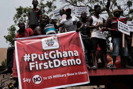 Demonstrators carry banners during a protest in Ghana's capital Accra against the expansion of its defence cooperation with the United States, Ghana March 28, 2018. REUTERS/Francis Kokoroko