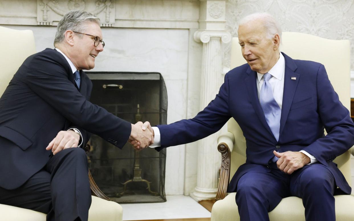 Biden and Starmer shake hands while speaking to reporters