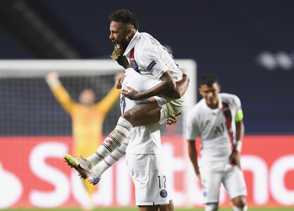 PSG's Neymar celebrates with teammate Eric Maxim Choupo-Moting after his team's win in the Champions League quarterfinal match between Atalanta and PSG at Luz stadium, Lisbon, Portugal, Wednesday, Aug. 12, 2020. (David Ramos/Pool Photo via AP)