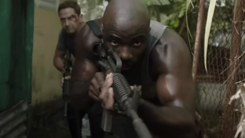 Men walking through jungle with guns