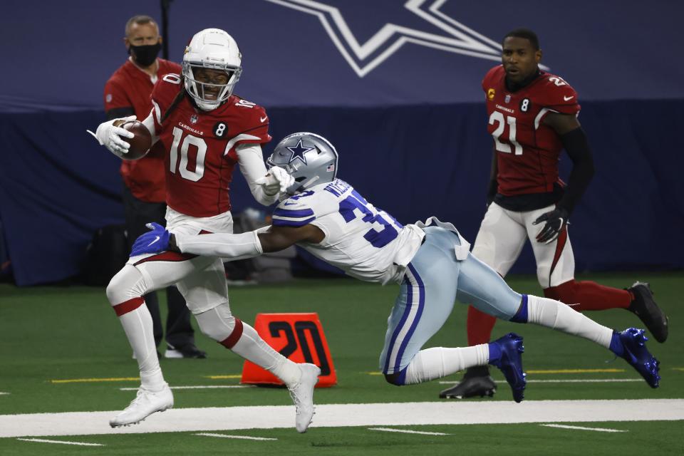 Arizona Cardinals wide receiver DeAndre Hopkins (10) is brought down after a long gain on a catch by Dallas Cowboys' Donovan Wilson (37) in the second half of an NFL football game in Arlington, Texas, Monday, Oct. 19, 2020. (AP Photo/Ron Jenkins)