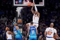 New York Knicks forward Obi Toppin (1) dunks as Charlotte Hornets forward P.J. Washington (25) and forward Cody Martin (11) look on during the first half of an NBA basketball game, Monday, Jan. 17, 2022, in New York. (AP Photo/John Minchillo)