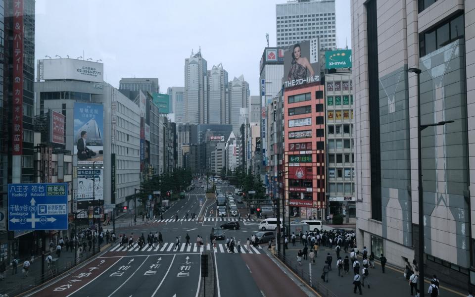 Morning commuters near Shinjuku Station in the Shinjuku district of Tokyo, Japan, on Friday, May 28, 2021. The Japanese government recommended extending a state of emergency that includes Tokyo and other major cities, trying to rein in coronavirus infections ahead of the capital hosting the Olympics in less than two months.  - Bloomberg