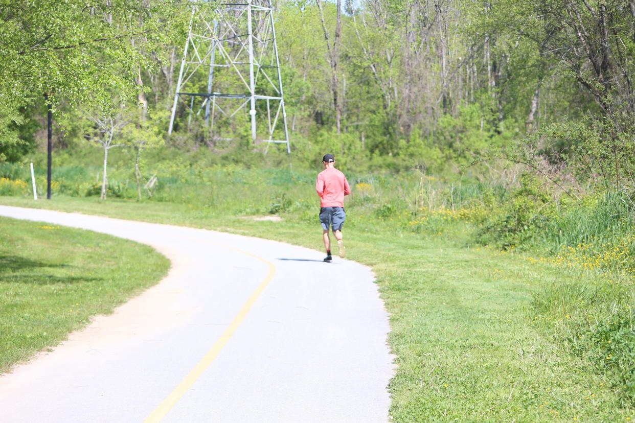 A man takes a morning jog along Oklawaha Greenway recently.