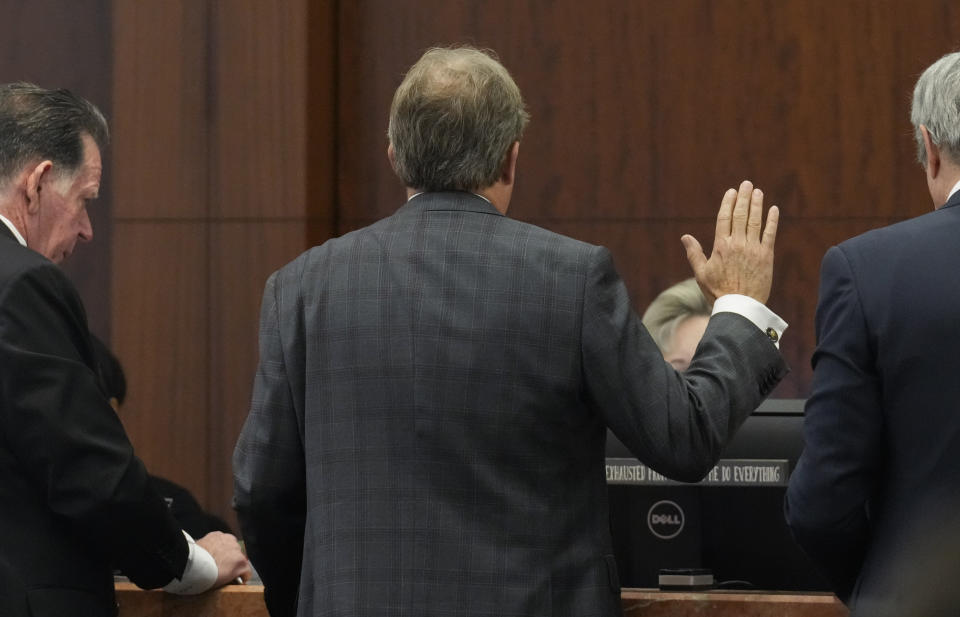 Texas Attorney General Ken Paxton is sworn-in at a pretrial hearing in his securities fraud case before state District Judge Andrea Beall in the 185th District Court Tuesday, March 26, 2024 at Harris County Criminal Courts at Law in Houston. Paxton, on Tuesday, agreed to pay nearly $300,000 in restitution under a deal to end criminal securities fraud charges that have shadowed the Republican for nearly a decade. (Yi-Chin Lee/Houston Chronicle via AP)