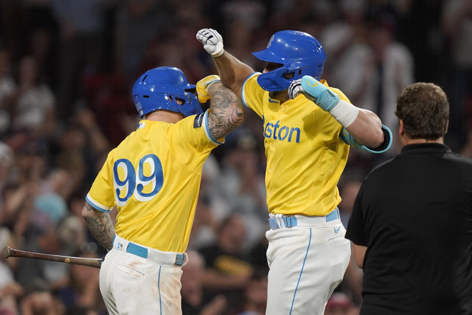 Boston Red Sox's Adam Duvall, right, celebrates with Alex Verdugo (99) after Duvall's home run against the Kansas City Royals during the fifth inning of a baseball game Tuesday, Aug. 8, 2023, in Boston. (AP Photo/Steven Senne)