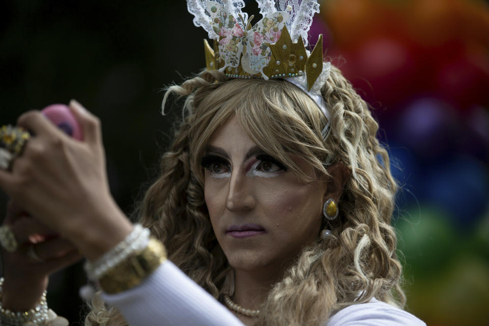 A reveler checks himself out on a vanity mirror before the start of the gay pride parade in Mexico City, Mexico, Saturday, June 29, 2019. (AP Photo/Fernando Llano)