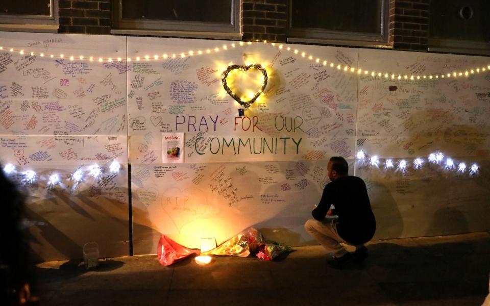 <p>A man reads messages of condolence on a wall near a tower block severely damaged by a serious fire, in north Kensington, West London, Britain, June 15, 2017. (Photo: Paul Hackett/Reuters) </p>