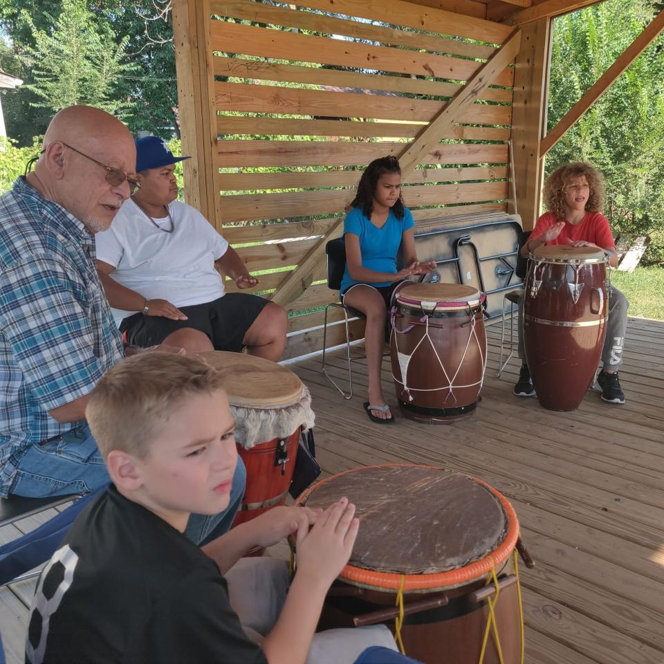 Osvaldo, Ozzie, Rivera teaches a drum circle to neighborhood children at La Casita Cimarrón y Yuketí in September 2022.