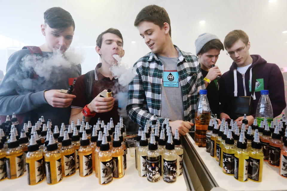 ST PETERSBURG, RUSSIA - MARCH 4, 2017: Teenaged visitors smoking electronic cigarettes at the 2017 Vapexpo Spb exhibition of the vape industry at Lenexpo. Sergei Konkov/TASS (Photo by Sergei Konkov\TASS via Getty Images)