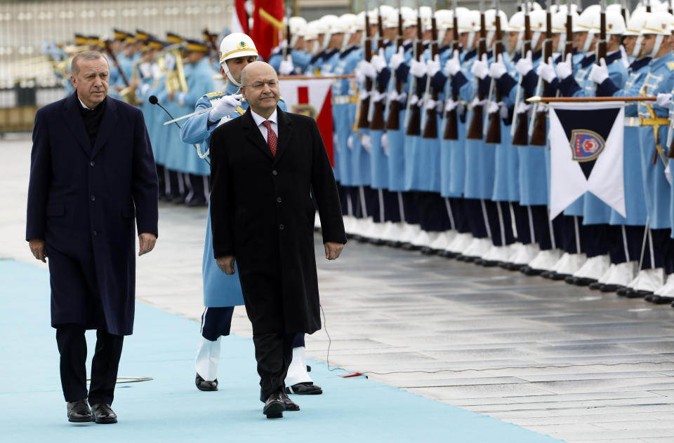 Turkey's President Recep Tayyip Erdogan, left, and Iraq's President Barham Salih inspect a military honour guard before their talks in Ankara, Turkey, Thursday, Jan. 3, 2019. The two were expected to discuss bilateral and regional issues, including Syria.(AP Photo/Burhan Ozbilici)