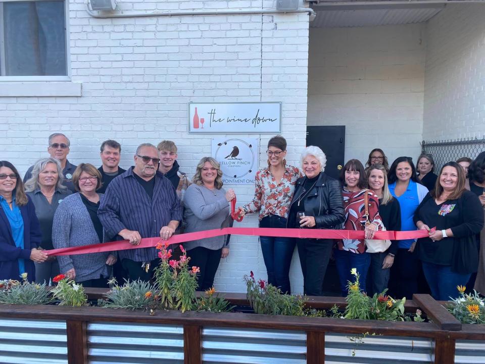 A joint ribbon cutting was held for Wine Down and Yellow Finch Creations, both located at 119 W. Huber St. in Marion.