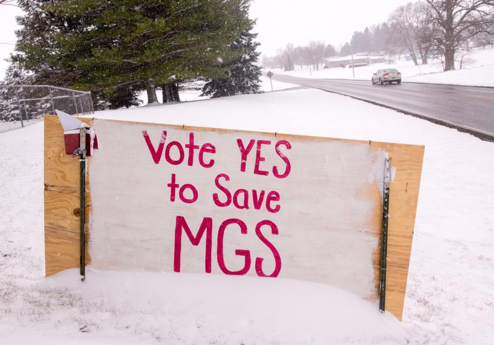 Traffic passes by a sign in a yard along the Metamora-Washington Blacktop asking for a "yes" vote for an upcoming tax referendum for Metamora Grade School.