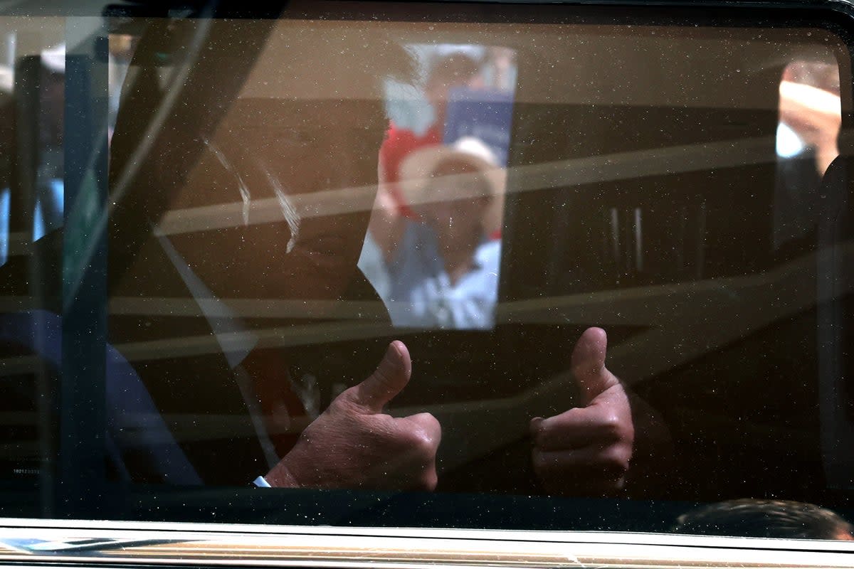 Donald Trump gives a thumbs up as his motorcade leaves federal court in Miami on 13 June after he pleaded not guilty to 37 charges in a sweeping indictment accusing him of illegally retaining classified documents and obstructing government efforts to retrieve them. (Getty Images)