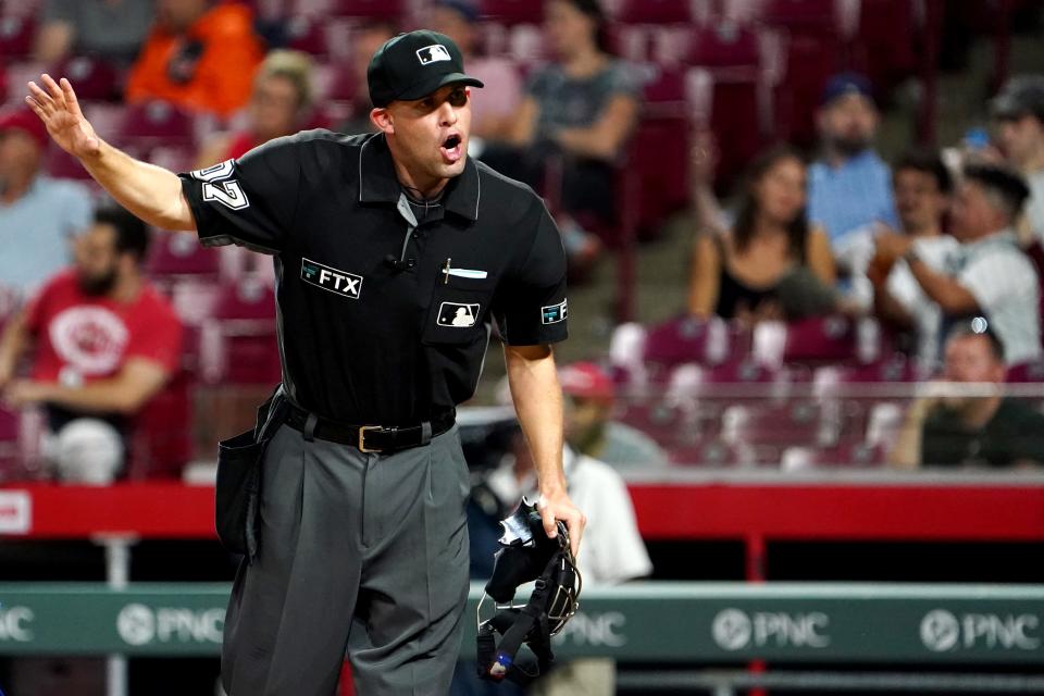 Home-plate umpire Dan Merzel (107) address the Chicago CubsÕ bench in the eighth inning during a baseball game against the Cincinnati Reds, Wednesday, May 25, 2022, at Great American Ball Park in Cincinnati. 