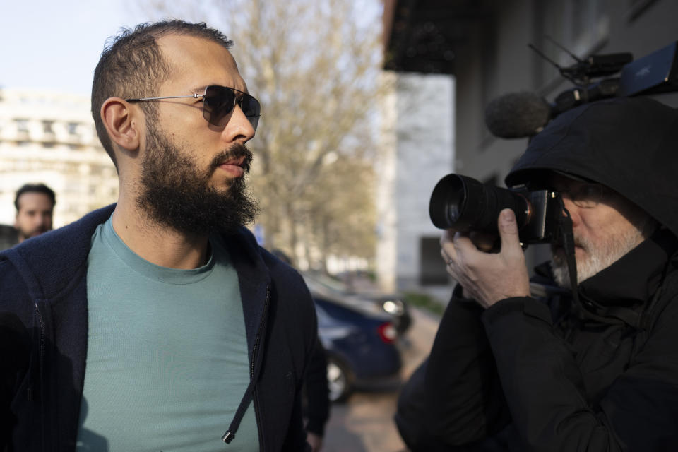 Andrew Tate and his brother Tristan arrive outside the Directorate for Investigating Organized Crime and Terrorism (DIICOT), where prosecutors examine electronic equipment confiscated during the investigation in their case, in Bucharest, Romania, Monday, April 10, 2023. (AP Photo/Vadim Ghirda)