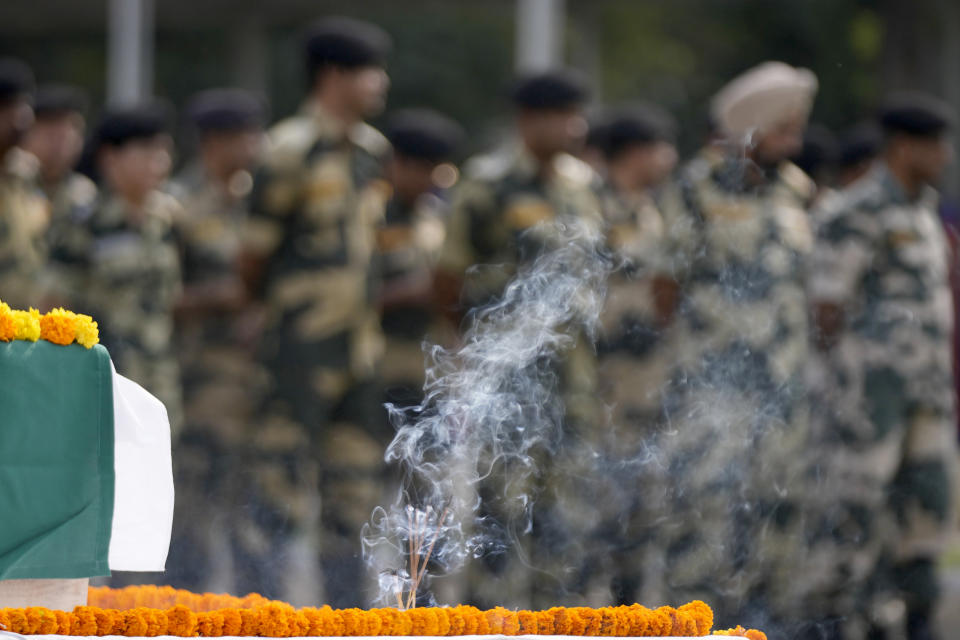 Indian Border Security Force (BSF) soldiers pay tribute to their colleague Lal Fam Kima during a wreath-laying ceremony at the BSF headquarters in Jammu, India, Thursday, Nov.9, 2023. The BSF soldier was killed as Indian and Pakistani soldiers exchanged gunfire and shelling along their highly militarized frontier in disputed Kashmir. (AP Photo/Channi Anand)