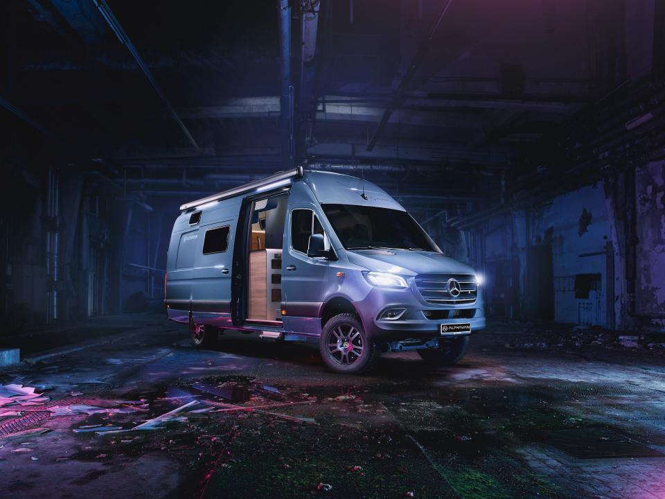 A rendering of the Alphavan in a purple and blue underground space.