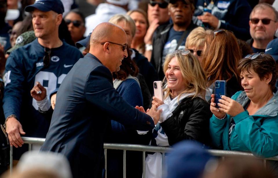 Penn State football coach James Franklin greets fans as he and the team arrive at Beaver Stadium for the game on Saturday, Sept. 24, 2022.