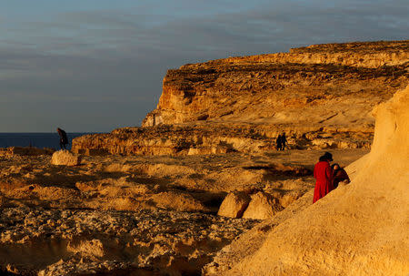 FILE PHOTO: Tourists walk near the spot where the natural arch known as the Azure Window used to stand before it collapsed into the sea last March after years of erosion, at Dwejra outside the village of San Lawrenz on the island of Gozo, Malta, January 25, 2018. REUTERS/Darrin Zammit Lupi/File Photo