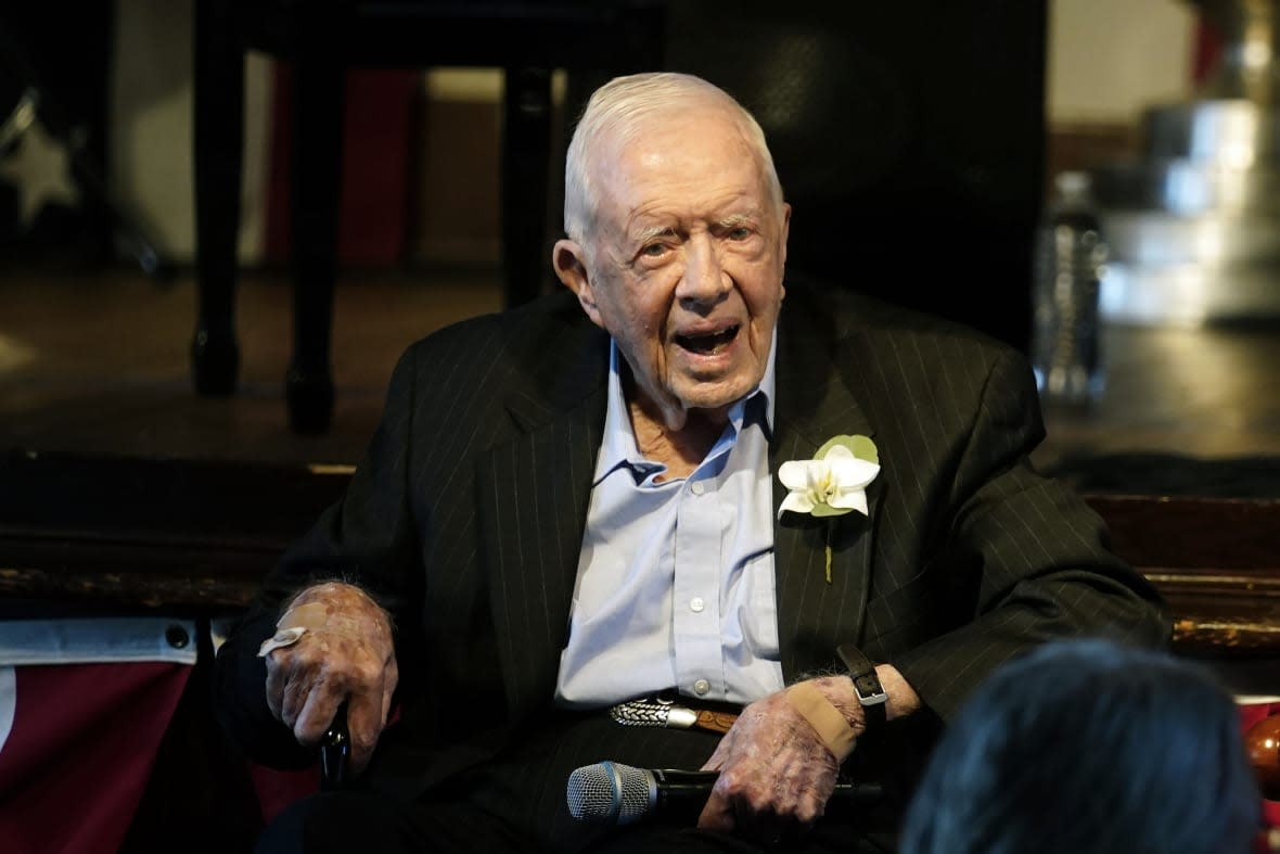 FILE – Former President Jimmy Carter reacts as his wife Rosalynn Carter speaks during a reception to celebrate their 75th wedding anniversary, July 10, 2021, in Plains, Ga. The Carter Center said Saturday, Feb. 18, 2023, that former President Jimmy Carter has entered home hospice care. The charity created by the 98-year-old former president said on Twitter that after a series of short hospital stays, Carter “decided to spend his remaining time at home with his family and receive hospice care instead of additional medical intervention.” (AP Photo/John Bazemore, Pool, File)