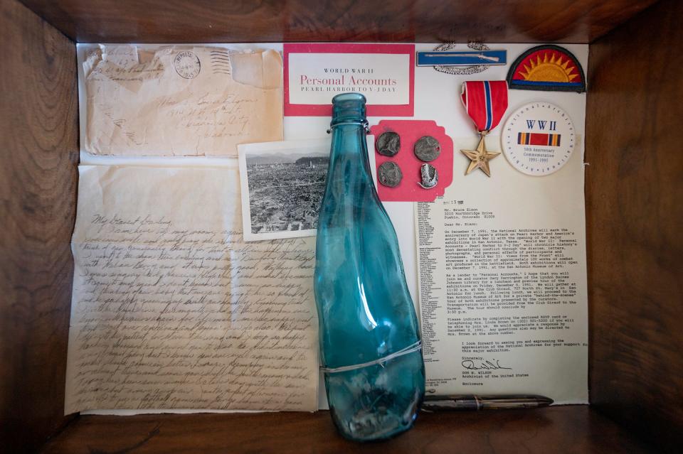 World War II veteran Bruce Elson was one of the first to see the city of Hiroshima after the bombing where he collected this sake bottle that was melted by the heat of the blast.