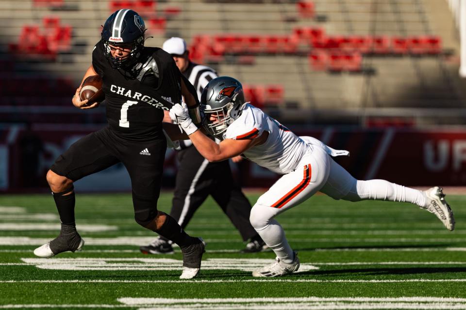 Corner Canyon High School’s Isaac Wilson runs the ball with Skyridge High School’s Noah Bird on defense during the 6A football state championship at Rice-Eccles Stadium in Salt Lake City on Friday, Nov. 17, 2023. | Megan Nielsen, Deseret News