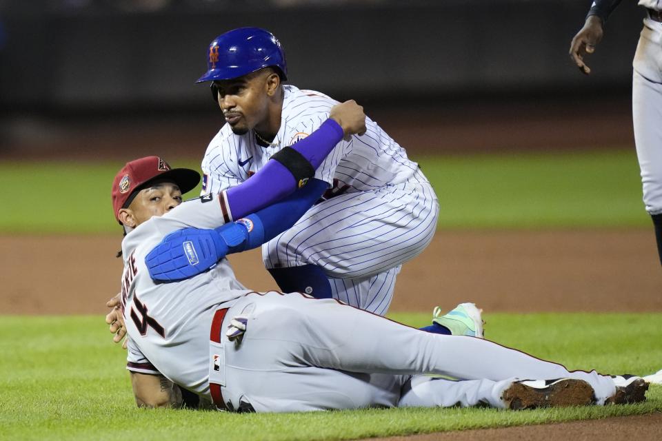 New York Mets' Francisco Lindor helps up Arizona Diamondbacks' Ketel Marte, left, after Martel tagged him out during the fifth inning of a baseball game Tuesday, Sept. 12, 2023, in New York. (AP Photo/Frank Franklin II)