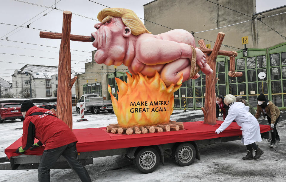 A political carnival float depicting former US president Donald Trump is rolled out to be shown in the streets in Duesseldorf, Germany, Monday, Feb. 15, 2021. Because of the coronavirus pandemic the traditional; carnival parades are canceled but eight floats are pulled through the empty streets in Duesseldorf, where normally hundreds of thousands of people would celebrate the street carnival. (AP Photo/Martin Meissner)