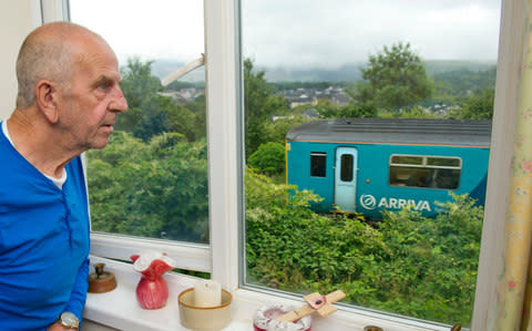 Rob Waistell looks out from the rear of his home on to the 'forest' of Japanese knotweed in Network Rail's land, which borders his property