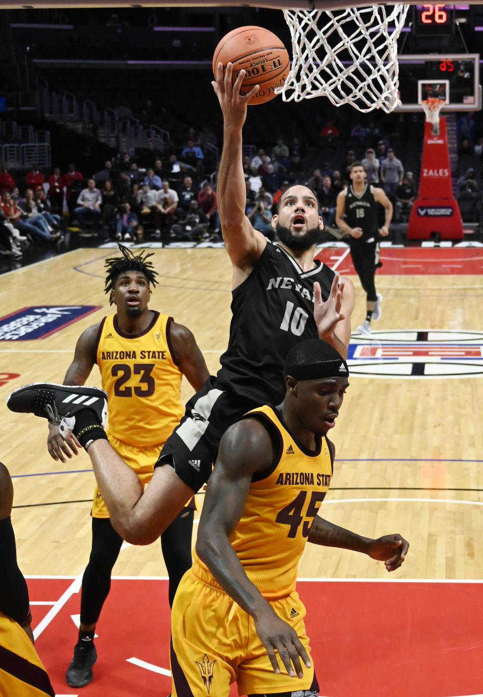 Nevada forward Caleb Martin, center, shoots as Arizona State forwards Romello White, left and Zylan Cheatham defend during the second half of an NCAA college basketball game at the Basketball Hall of Fame Classic on Friday, Dec. 7, 2018, in Los Angeles. (AP Photo/Mark J. Terrill)