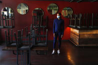 In this Thursday, May 21, 2020, image, Stephanie Byrd, co-owner of The Block, poses for a photo with chairs on the tables while the restaurant is closed due to the coronavirus in Detroit. She’s worried other black-owned businesses will struggle to withstand another wave of economic uncertainty during the pandemic, following decades of inequity that made it hard for many to flourish in the first place. (AP Photo/Paul Sancya)