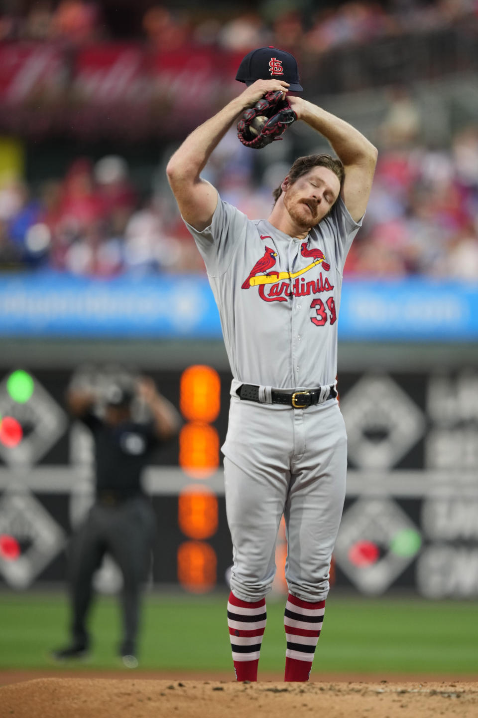 St. Louis Cardinals pitcher Miles Mikolas wipes his face during the first inning of a baseball game against the Philadelphia Phillies, Friday, Aug. 25, 2023, in Philadelphia. (AP Photo/Matt Slocum)