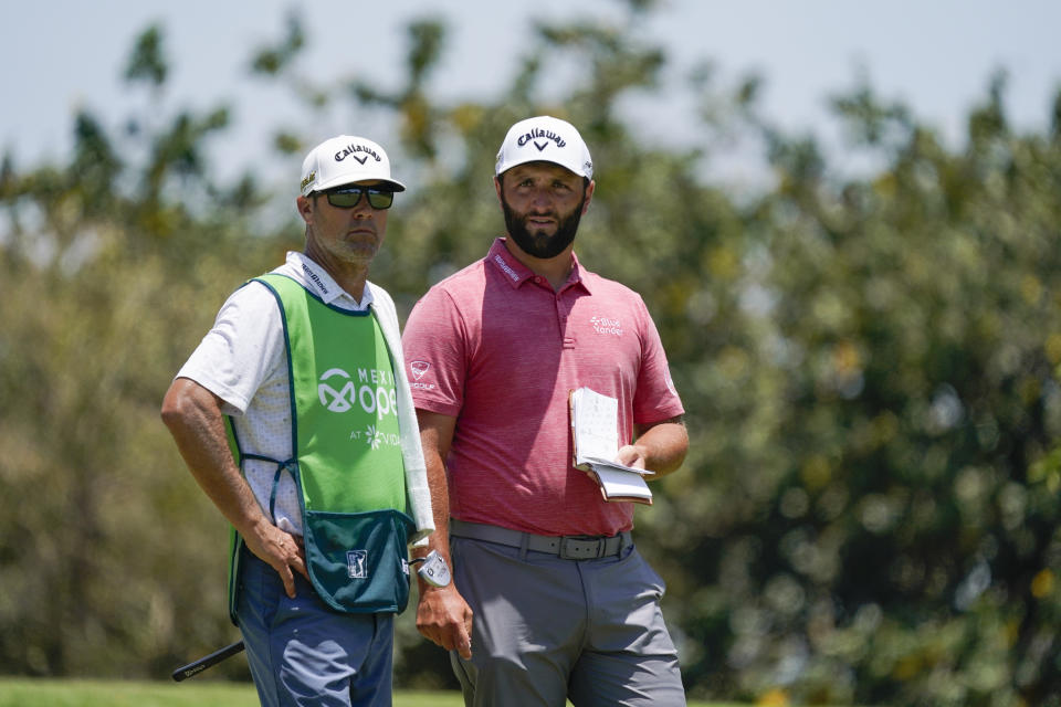 Jon Rahm, of Spain, and his caddie stand on the sixth hole during the final round of the Mexico Open at Vidanta in Puerto Vallarta, Mexico, Sunday, May 1, 2022. (AP Photo/Eduardo Verdugo)