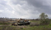 A Russian tank damaged in recent fighting is seen in the field near the recently retaken village of Kamianka, Kharkiv region, Ukraine, Sunday, Oct. 30, 2022. (AP Photo/Efrem Lukatsk)