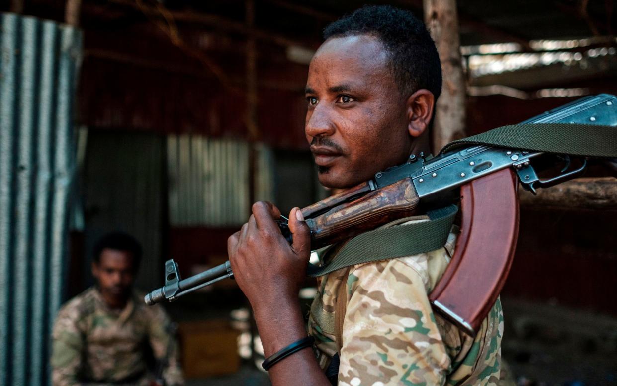 A member of the Amhara Special Forces looks on as he holds his rifle at the 5th Battalion of the Northern Command of the Ethiopian Army in Dansha, Ethiopia - AFP