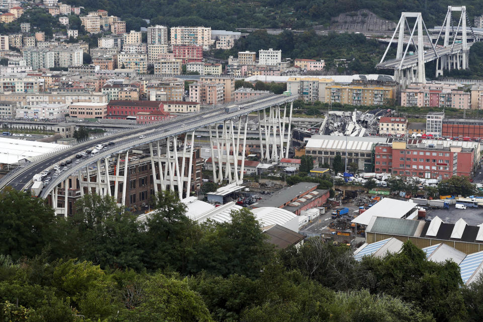 FILE - In this Tuesday, Aug. 14, 2018, file photo, vehicles are blocked on the Morandi highway bridge after a section of it collapsed in Genoa, northern Italy, killing 43 people. The new bridge is being inaugurated Monday, Aug. 3, 2020. (AP Photo/Antonio Calanni, File)
