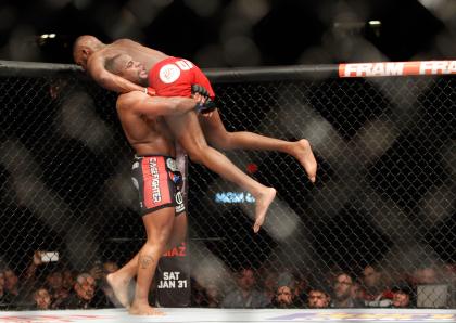 Daniel Cormier lifts up Jon Jones before a slam during their UFC 182 fight. (Getty)