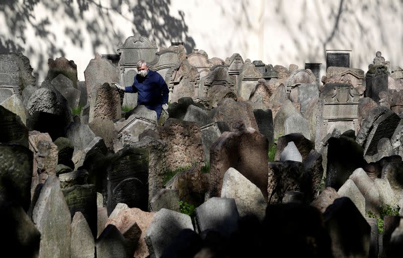 A gardener works at the Old Jewish Cemetery in Prague