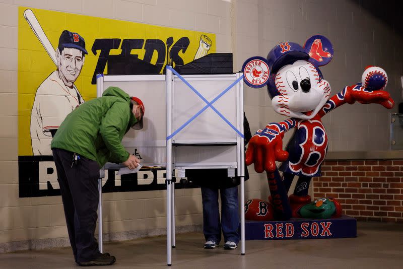 A voter fills out his ballot at Fenway Park on the first day of early voting in Boston