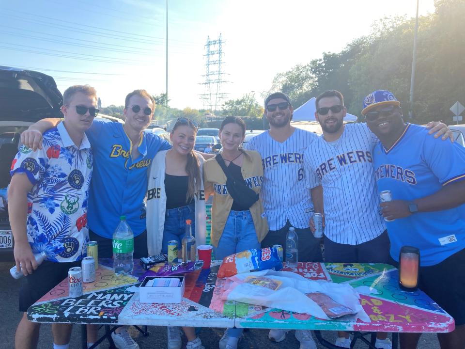 A group of friends who know each other from high school and college tailgates before the Milwaukee Brewers game on Oct. 3. They borrowed a table that hailed from a basement on the east side. From left: Kyle Jansen, Quinn Hyndiuk, Kendall Barlow, Caitlin Campbell, Frank Mistrioty, Connor Tanel and Sam McComis.