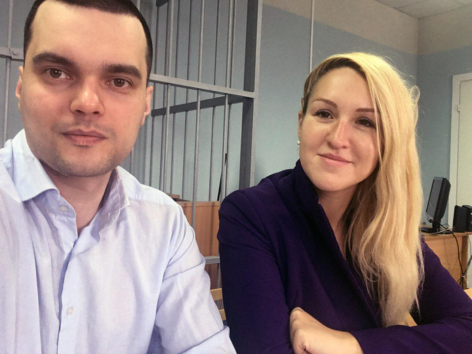 In this handout photo released by the Foundation for Fighting Corruption, Dr. Anastasia Vasilyeva of the Alliance of Doctors union, right, and the Foundation for Fighting Corruption's lawyer Vyacheslav Gimadi sit in court room in Okulovo, Novgorod region, about 400 kilometers (about 250 miles) northwest of Moscow, Russia, Friday, April 3, 2020. An activist doctor who had criticized Russia's response to the coronavirus outbreak was forcibly detained as she and some of her colleagues tried to deliver protective gear to a hospital in need. The new coronavirus causes mild or moderate symptoms for most people, but for some, especially older adults and people with existing health problems, it can cause more severe illness or death. (The Foundation for Fighting Corruption via AP)