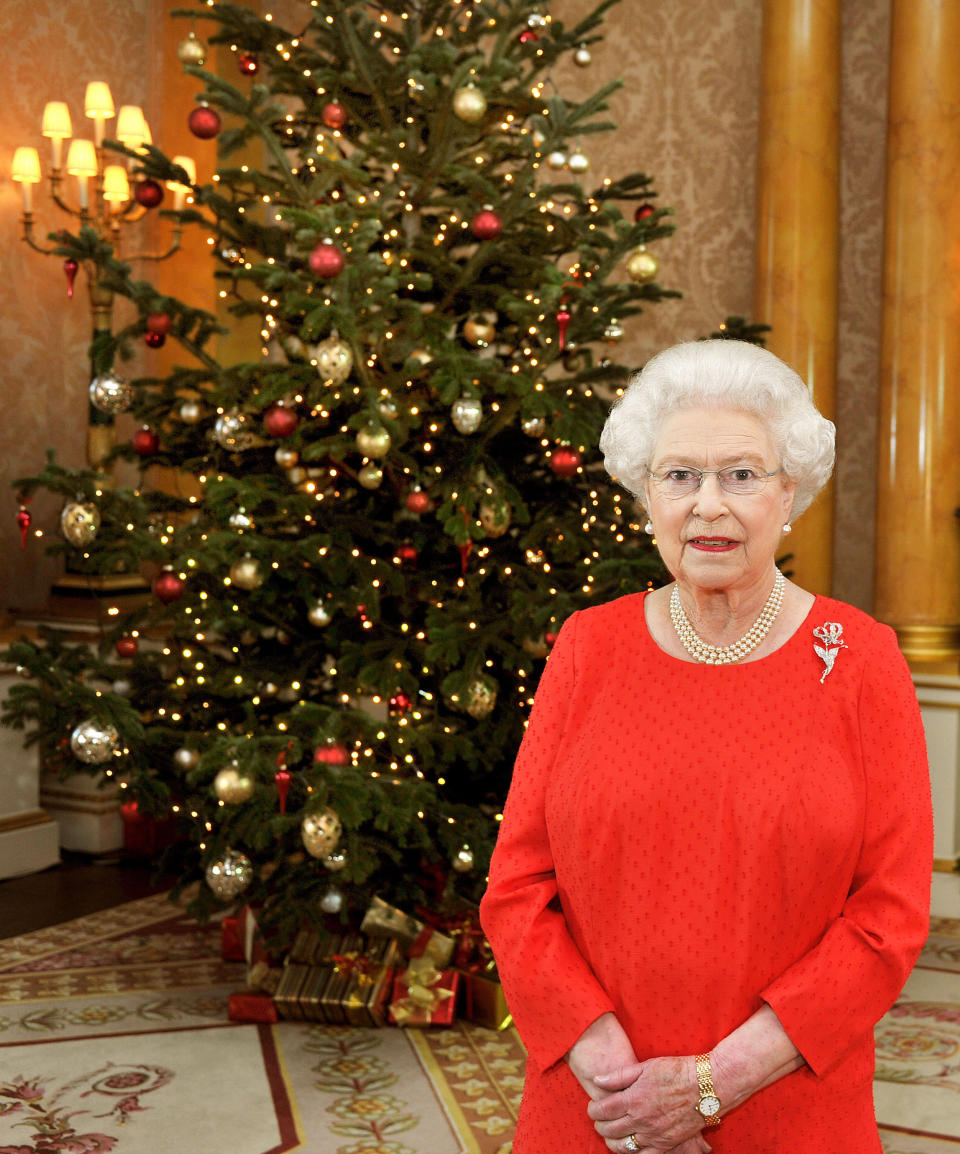 LONDON, UNITED KINGDOM  - DECEMBER 19:   Queen Elizabeth II stands in front of a Christmas tree at Buckingham Palace after recording her Christmas Day television broadcast to the Commonwealth on December 15, 2011 in London, England. (Photo by Rota/ Anwar Hussein/Getty Images)