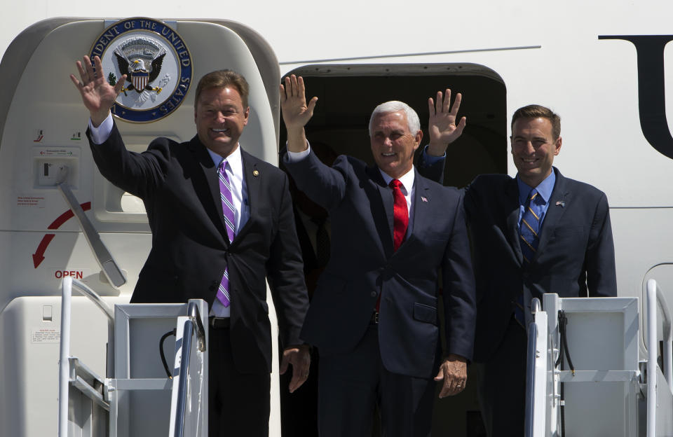 Vice President Mike Pence, center, is accompanied by Sen. Dean Heller, left, R-Nev, and Nevada Attorney General Adam Laxalt, Republican candidate for Nevada governor, after arriving at Nellis Air Force Base in Las Vegas, Friday, Sept. 7, 2018. (Steve Marcus/Las Vegas Sun via AP)