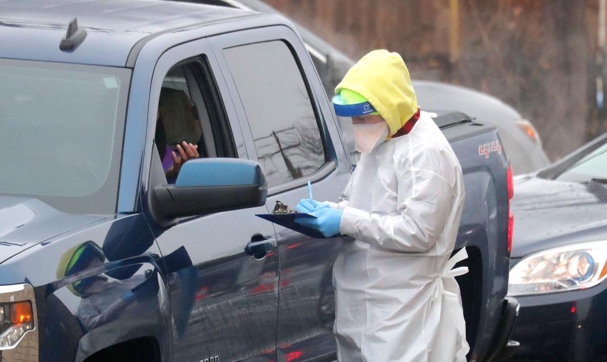 A person is checked in for a COVID-19 test at the Northwest Health Center free COVID-19 testing site on West Mill Road in Milwaukee on Dec. 27.