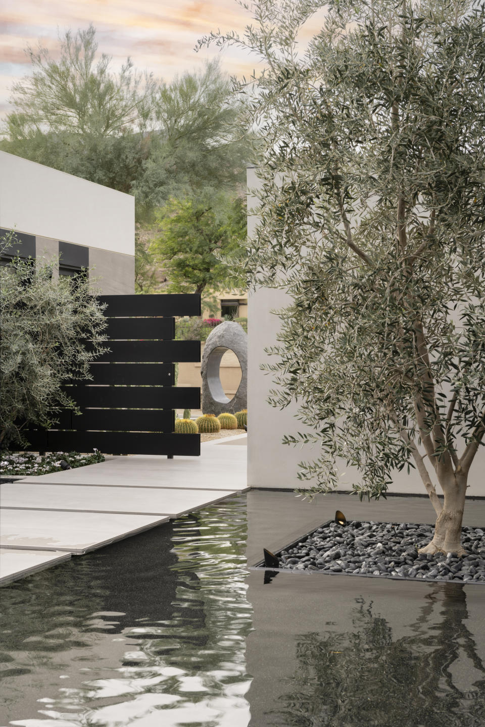 A water feature runs along a front yard pathway