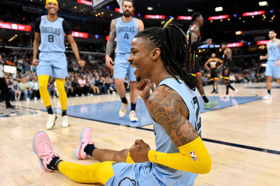 Memphis Grizzlies guard Ja Morant, foreground, reacts in the second half of an NBA basketball game against the Phoenix Suns, Monday, Jan. 16, 2023, in Memphis, Tenn. (AP Photo/Brandon Dill)